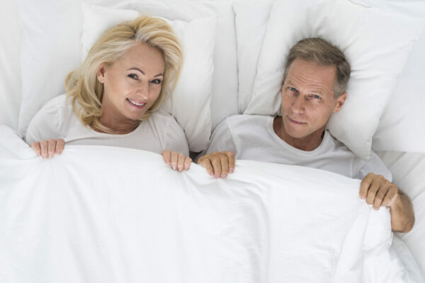 top-view-cute-couple-sitting-bed-rotated